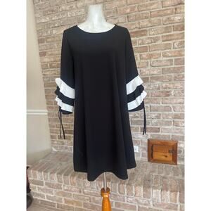 Black shift dress with white ruffled sleeves and tie details!